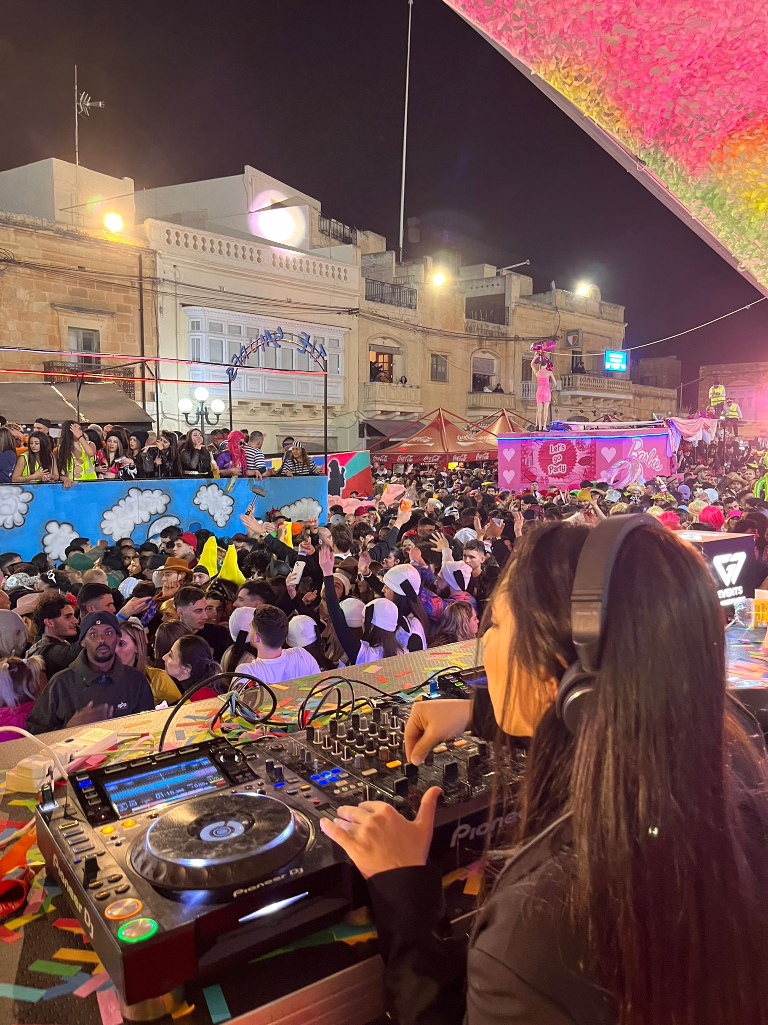 Group enjoying DJ SAR's music, led by a female DJ.