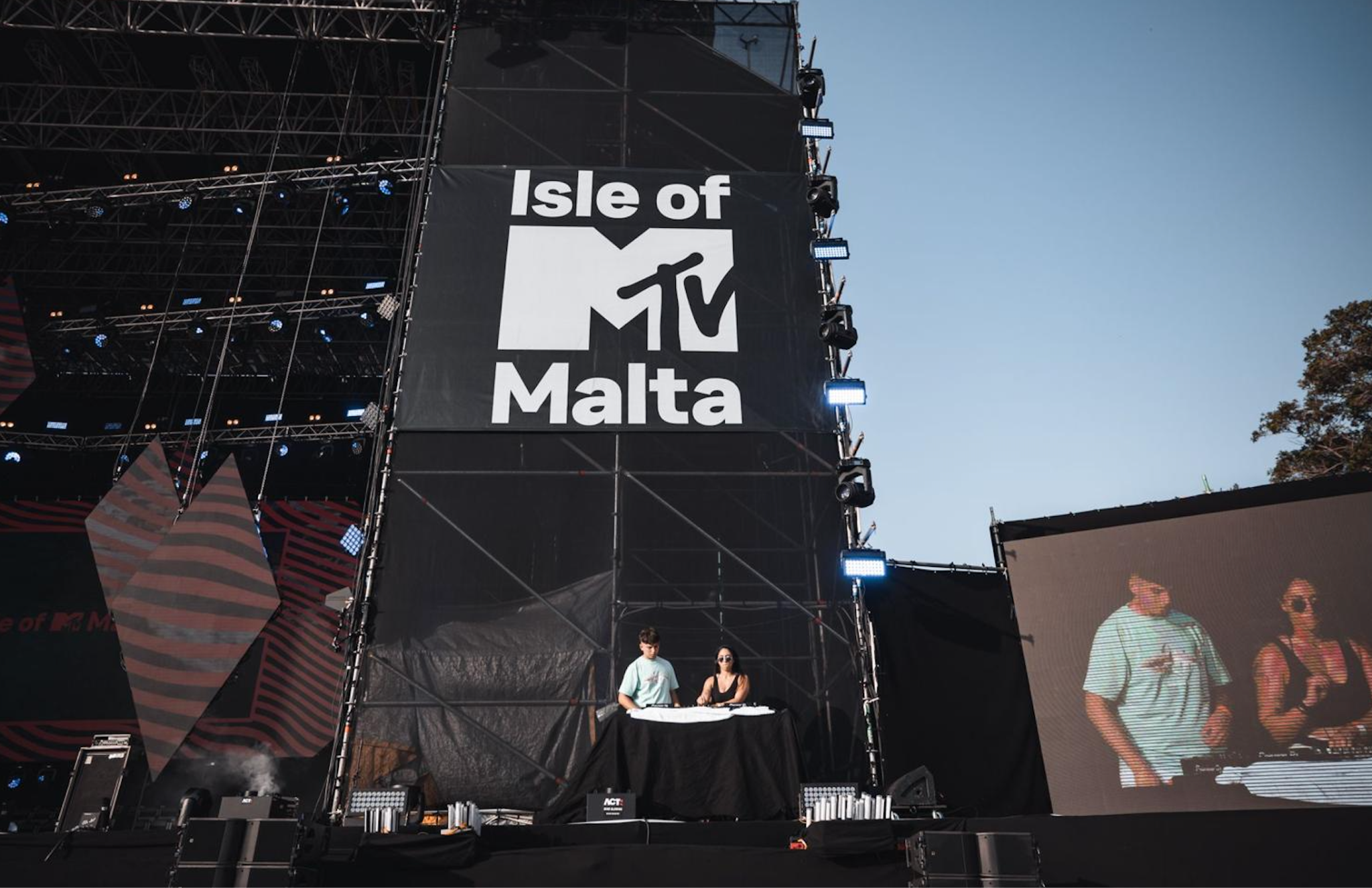 DJ SAR with fellow DJ, showcasing skills against a black background with "Isle of MTV Malta."