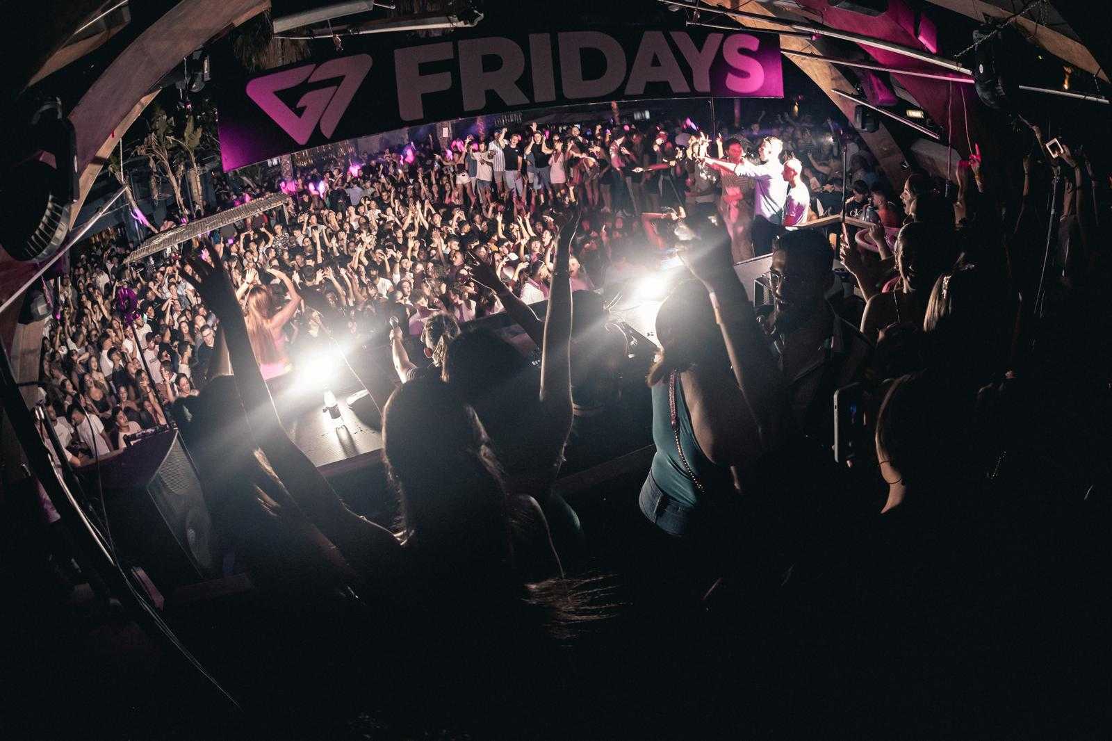 Nightclub scene with DJ booth, colorful lights, and "FRIDAYS" banner above.